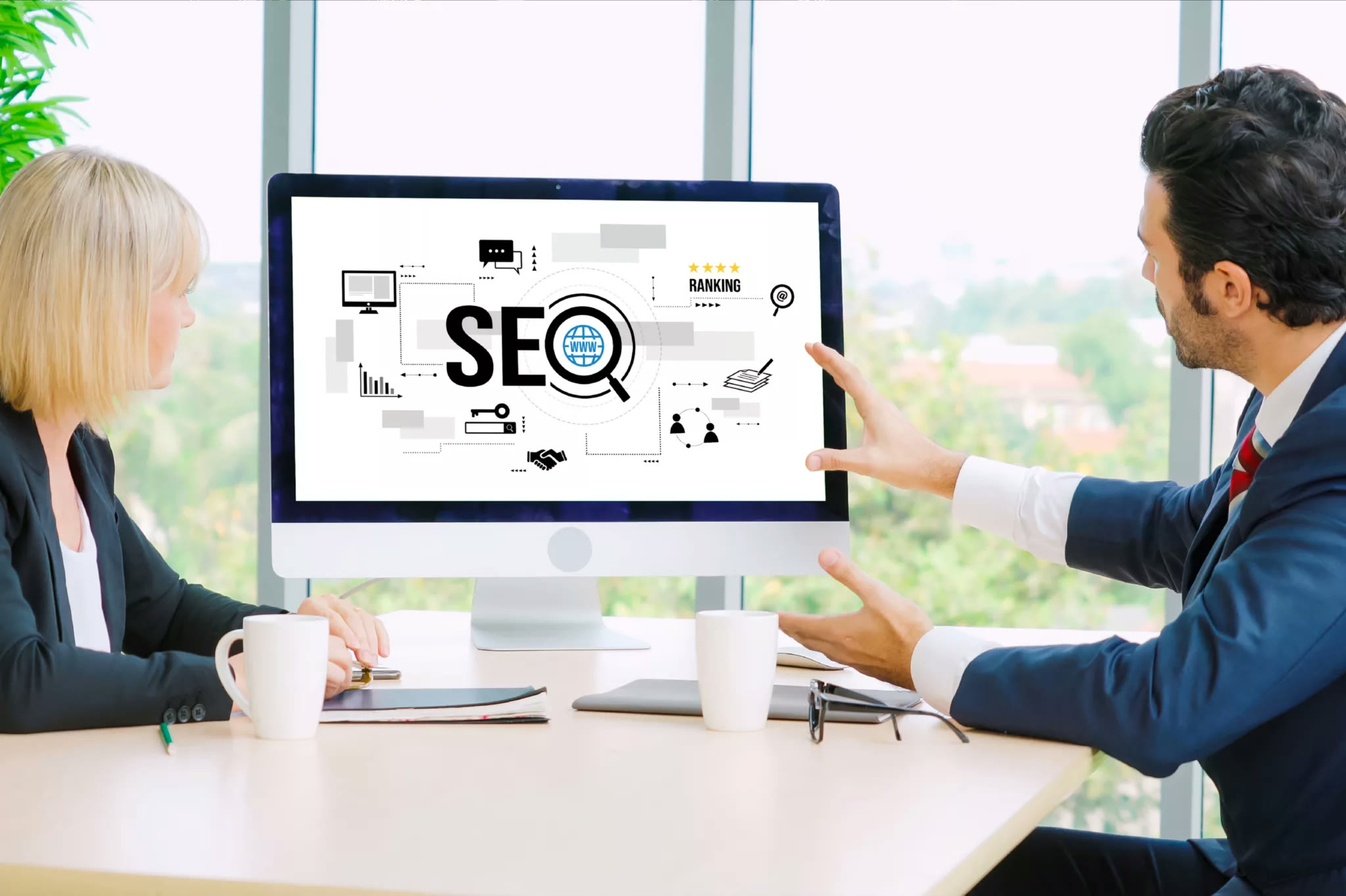 Presenter pointing at an SEO diagram on a whiteboard